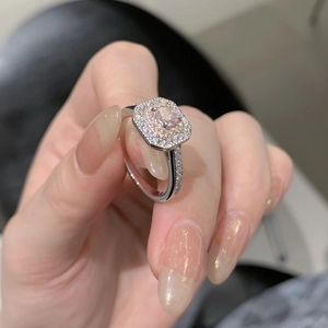 Macro shot of S925 silver ring featuring square pink gem and double halo setting