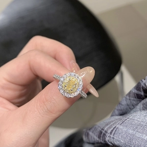 Macro detail of oval yellow zircon ring with halo micro-pave setting on silver band