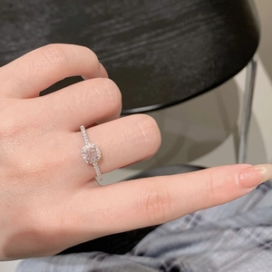 Macro detail of S925 sterling silver ring with cushion-cut pink center stone and halo setting