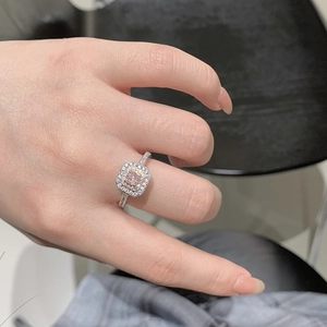 Close-up of S925 silver ring featuring square pink stone with double halo setting on hand