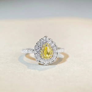 Pear cut yellow diamond ring with double halo setting and pavé zircon band in 925 silver