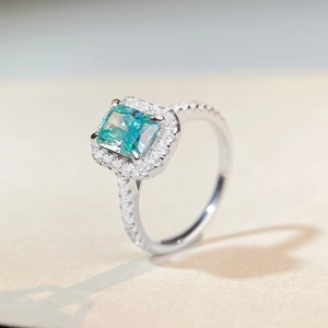 Radiant cut mint green moissanite halo ring in polished white gold plating