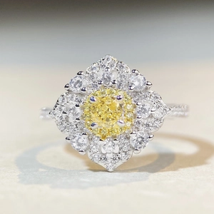 Macro detail of S925 silver ring featuring a yellow cushion cut stone and halo diamonds