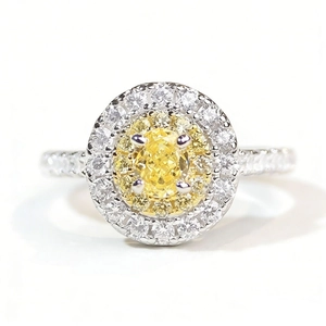 Elegant sterling silver ring featuring a yellow oval zircon with a double halo pave setting