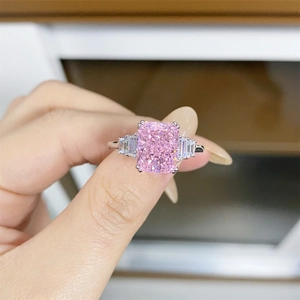 Macro detail of 925 silver ring featuring a large pink emerald cut zircon stone