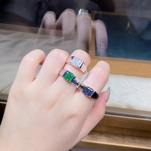 Close-up of three 925 silver men's rings with square-cut white, green and blue zircons