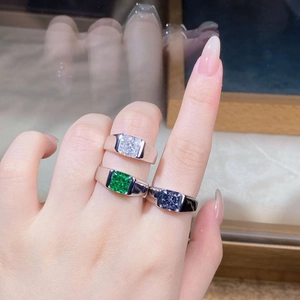 Close-up of S925 silver rings set with square-cut clear, emerald and purple gemstones