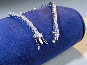Macro shot of 2.5mm Moissanite tennis bracelet with secure double-lock safety clasp