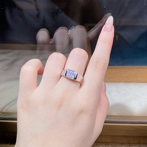 Close-up of 925 silver ring with large square clear stone and blue side gemstones