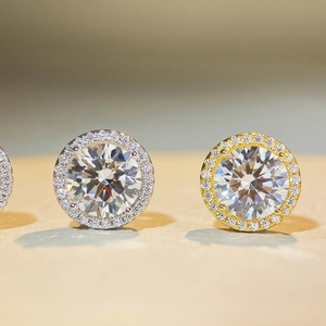 Detailed macro view of S925 sterling silver halo stud earrings in gold and silver tones