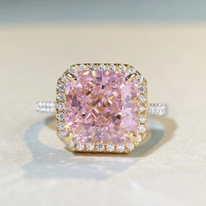 Macro view of cushion cut pink zircon halo ring with pavé diamond band setting