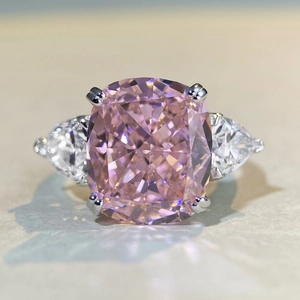 Macro shot of cushion-cut pink gemstone with pear-shaped side diamonds on S925 silver ring