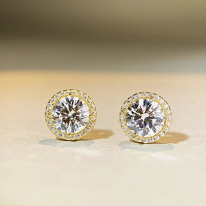 Macro detail of S925 silver 1ct moissanite stud earrings with a gold halo setting