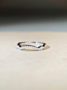 Macro shot of V-shaped sterling silver ring with shimmering pavé set cubic zirconia