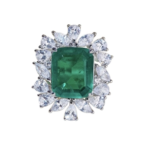 Luxurious S925 silver ring featuring emerald cut green stone and pear shape diamonds