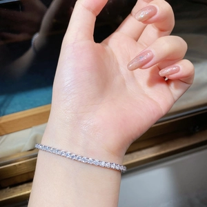 Close-up of S925 sterling silver tennis bracelet with 2.5mm round cut moissanite on wrist