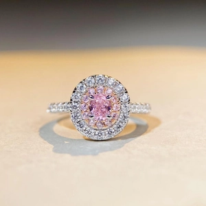 Detailed close-up of a double halo pink oval gemstone ring in S925 sterling silver
