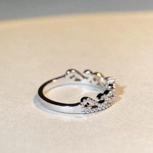 Macro detail of S925 silver infinity crown ring with shimmering pave-set zircon stones