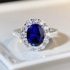 Luxurious S925 silver halo ring featuring an oval sapphire and surrounding crystals