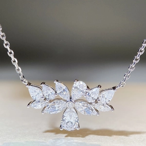 Macro detail of S925 silver necklace with marquise and pear-cut floral zircon pendant