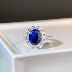 Elegant S925 silver ring featuring an oval blue sapphire halo set with brilliant diamonds