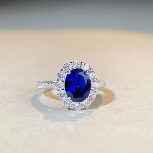 Close-up of a luxury S925 silver ring featuring a large oval sapphire and halo diamonds