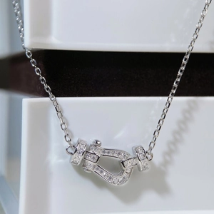 Macro view of silver horseshoe buckle pendant with shimmering cubic zirconia stones