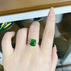 S925 sterling silver ring with 4ct emerald-cut green gemstone on a woman's finger