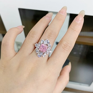 Macro shot of S925 silver ring featuring radiant cut pink gem and floral halo crystals