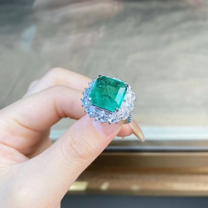 Luxury S925 silver ring featuring emerald cut green stone with double halo diamond setting