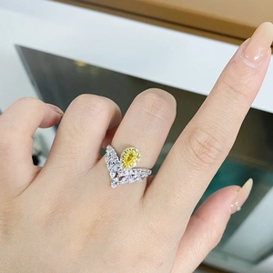 Close-up of a V-shaped S925 silver ring featuring a sparkling yellow pear-cut gemstone