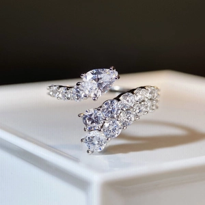 Macro shot of S925 sterling silver bypass ring with pear cut and round cluster diamonds