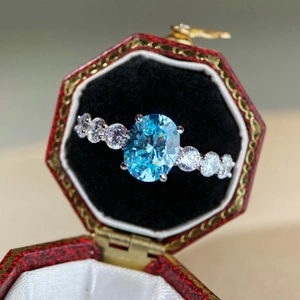 Elegant S925 silver ring featuring an oval blue gemstone in a vintage red gift box