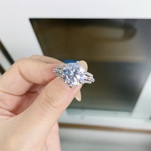 Close-up of 5ct moissanite ring with four-prong setting and side diamond accents