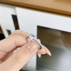 S925 sterling silver ring featuring a 1 carat oval cut moissanite and pavé set band