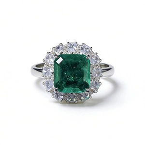 S925 sterling silver ring featuring a halo-set emerald cut green gemstone with diamonds