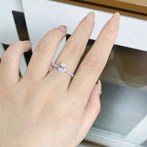Close-up of a 1 carat oval-cut moissanite silver ring shown on a finger