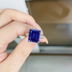 Classic 925 sterling silver ring with large emerald-cut blue tanzanite and pavé side diamonds