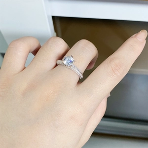 Close-up of S925 sterling silver moissanite ring with six-prong setting and micro-pave band