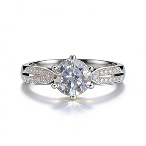 Classic six-prong moissanite engagement ring with pavé diamonds on a wide silver band