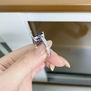 Close-up of 925 silver ring with 10x12mm blue gemstone and four-claw setting details
