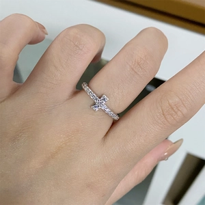 Minimalist S925 silver cross ring with pavé white zircons worn on female hand