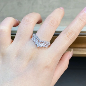 Macro detail of V-shaped sterling silver chevron ring featuring five marquise-cut zircons