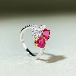 Macro shot of S925 sterling silver ring with heart-shaped red rubies and pavé diamonds