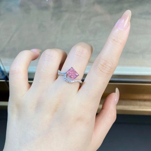 Macro detail of radiant cut pink gemstone ring with wavy pavé sterling silver band