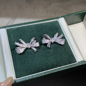 Detailed close-up of S925 silver bow earrings with micro-paved sparkling zircons