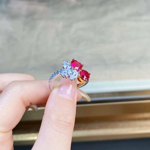 Detail of S925 silver ring featuring double heart red gemstones and sparkling zircon accents