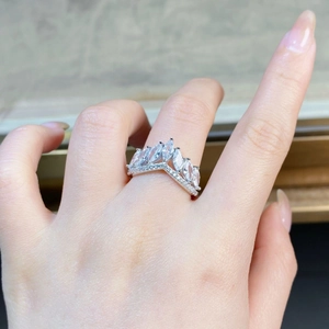 Detail of V-shaped 925 silver crown ring with marquise cut stones worn on finger