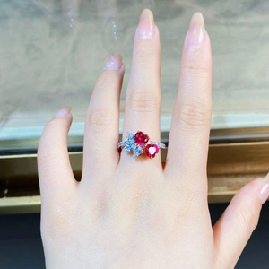 Close-up of double heart-shaped red rubies with white diamonds on a silver ring