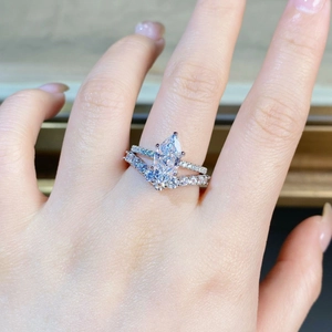Marquise-cut diamond ring set with V-shaped pavé band shown on model hand